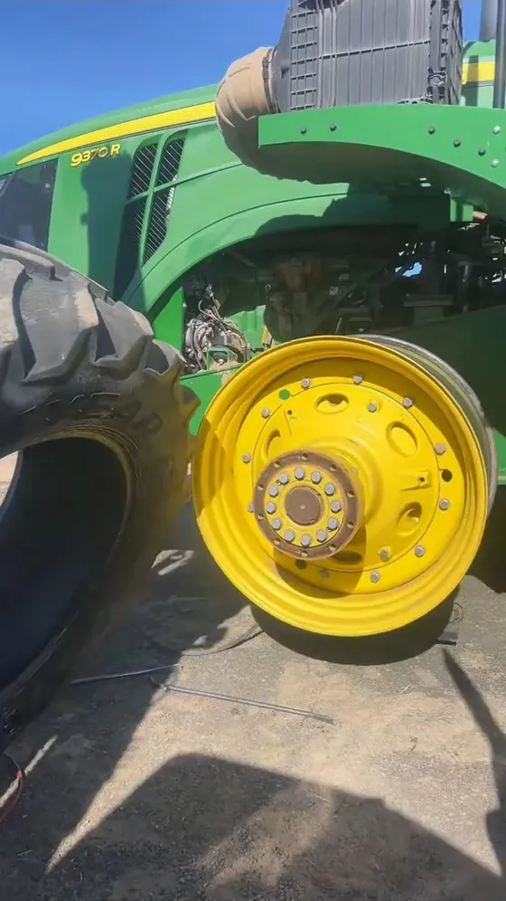 John Deere 9370R tractor with the tire removed showing the bare yellow wheel